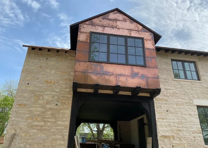 Copper metal panel facade on a stone building for Skylight Installation in Antelope